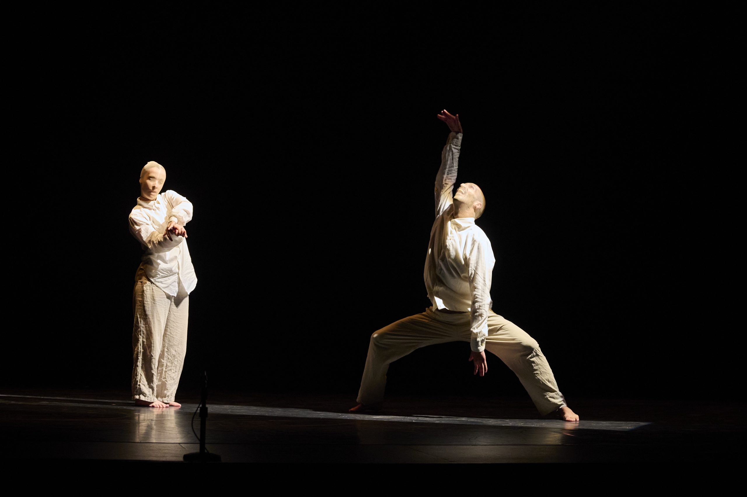 Dos personas con medias en la cabeza haciendo figuras corporales de danza